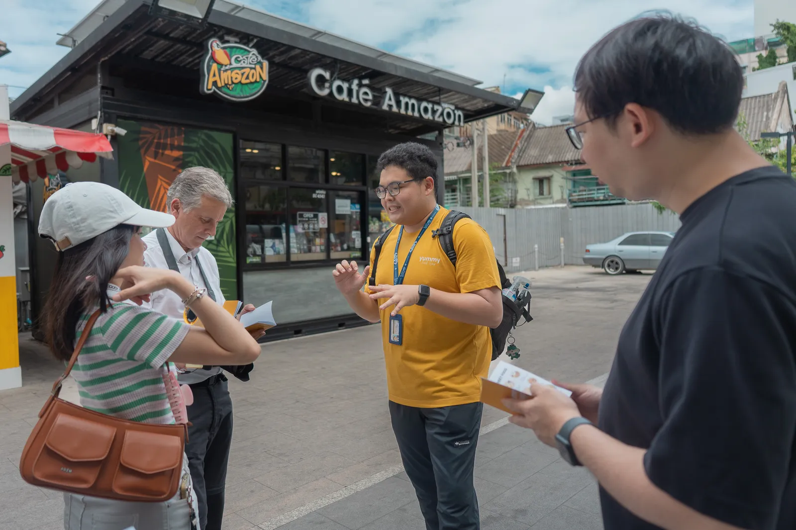 A Yummy guide welcoming explorers on the street